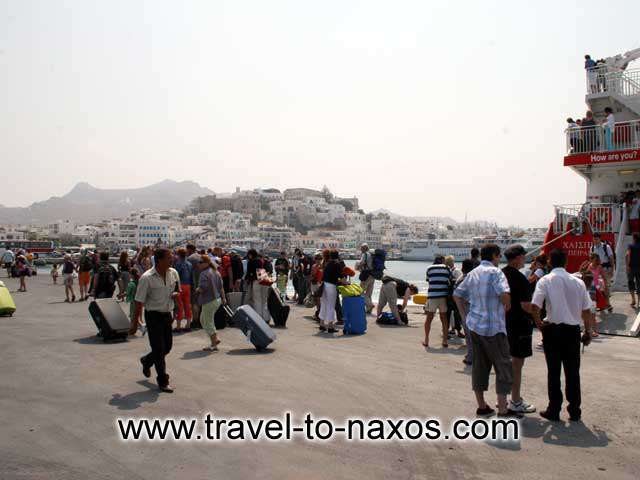 NAXOS PORT - Tourists arriving in Naxos and the castle in the background