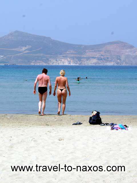 COUPLE SWIMMING - A couple entering the sea at Agios Georgios beach
